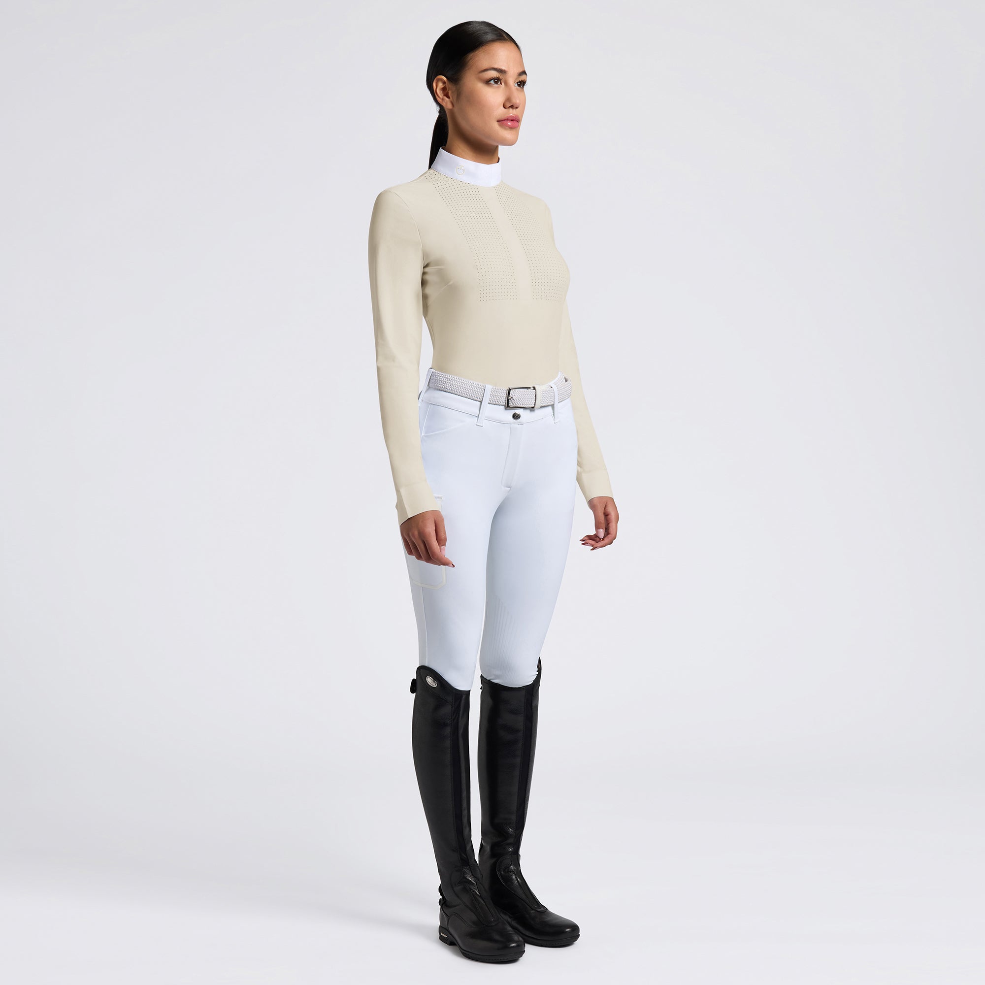 Capture the essence of the Cavalleria Toscana Heat Sealed Perforated Bib Long Sleeve Competition Shirt with images that highlight its unique features. Focus on the heat-sealed perforated bib detail, the tailored fit, and the lightweight technical fabric. Use a mix of action shots in a competitive setting and close-ups that showcase the shirt&