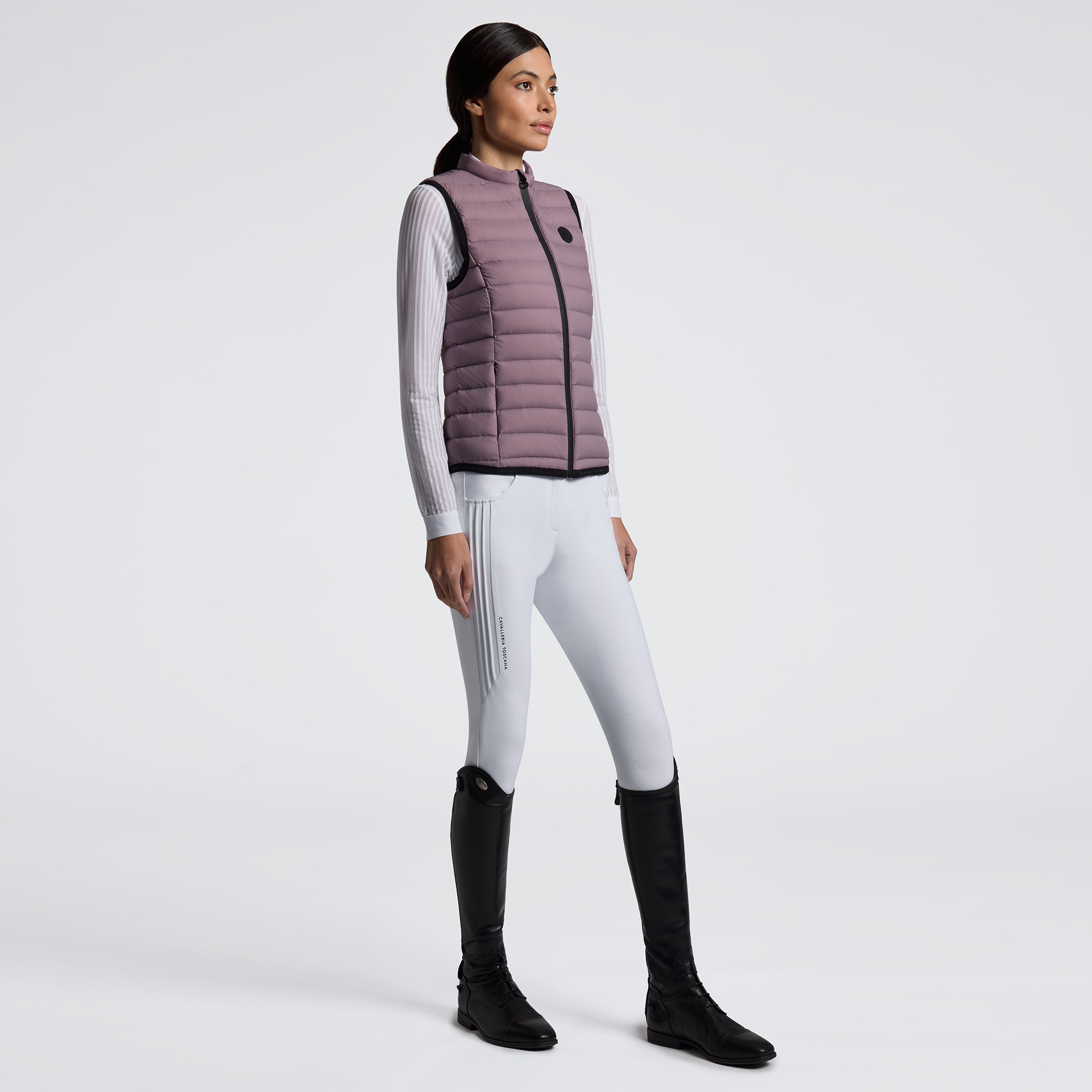 Experience unmatched comfort and style with the Cavalleria Toscana Lightweight Vest. Designed for breathability and ease of movement, this vest is perfect for layering during training or casual outings. Its sleek design ensures you stay both warm and fashionable without feeling weighed down. Elevate your equestrian wardrobe with this versatile, lightweight essential.