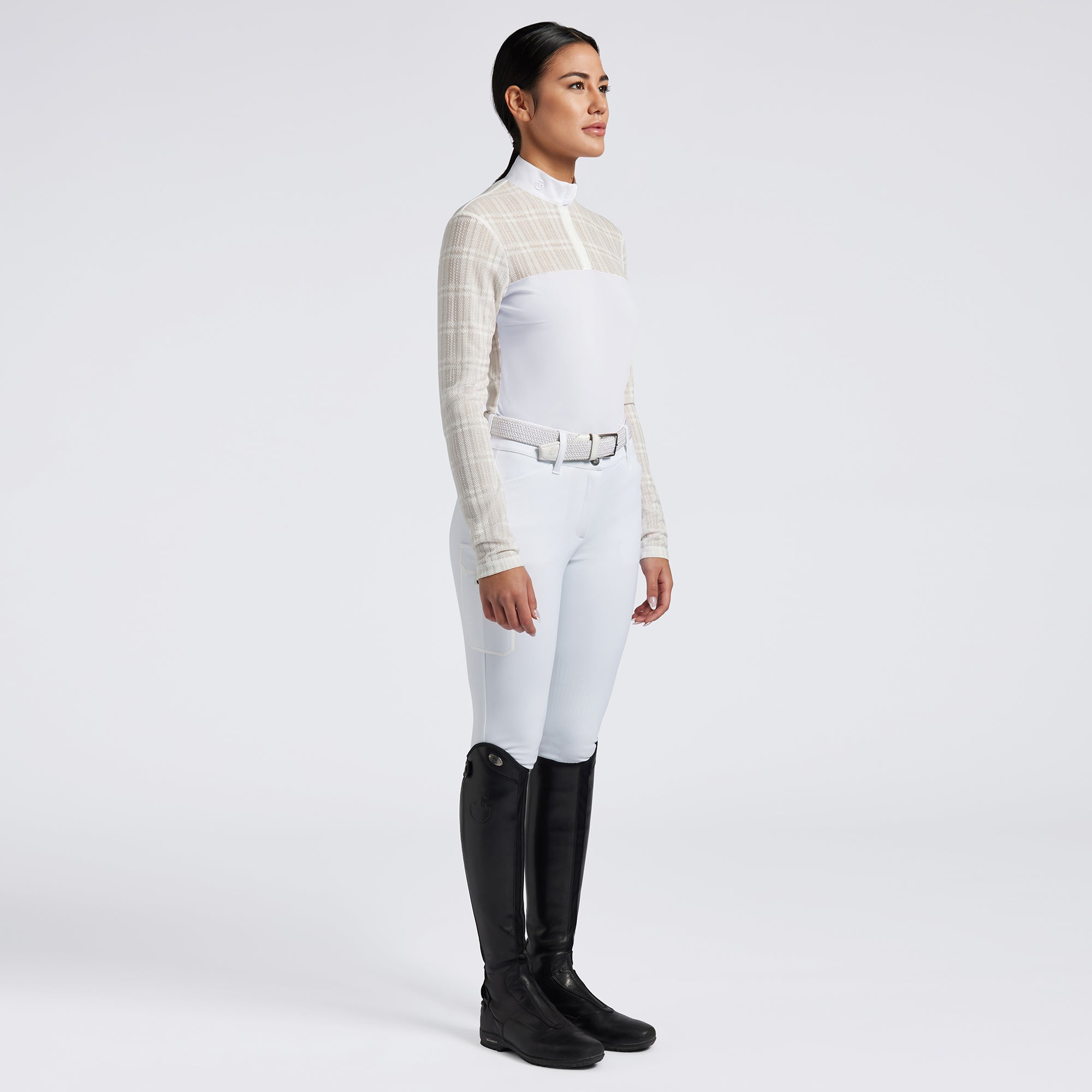 Showcase the Cavalleria Toscana Sheer Jacquard Jersey Zip Competition Shirt with images that emphasize its lightweight and breathable fabric. Highlight the sheer jacquard jersey material, zip closure, and tailored fit through a mix of close-up shots and action shots in an equestrian setting. Focus on the shirt&