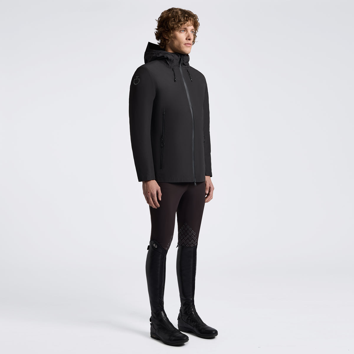 Man in black coat on white background