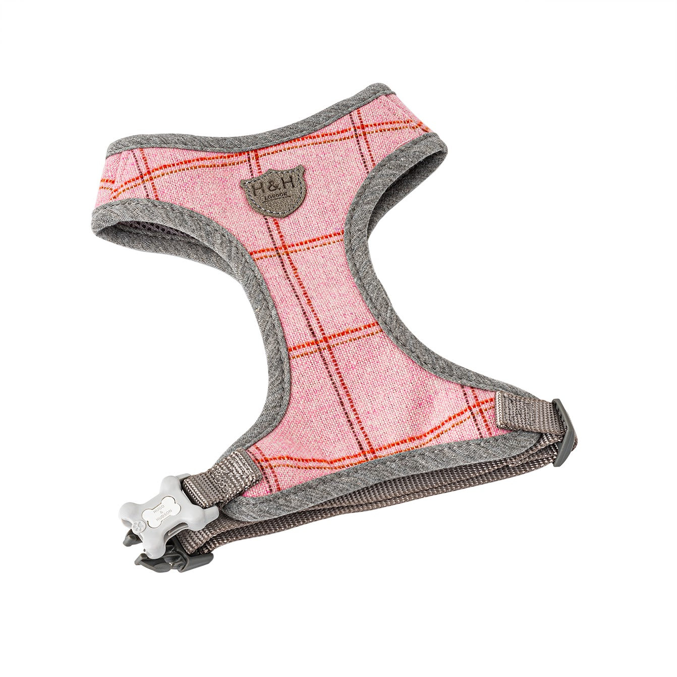 Hugo and Hudson Pink Tweed Harness The pink dog harnesses are designed to help prevent your dog from pulling, whilst reducing pressure on their neck. The harness is designed so your dog will look and feel great, with four different sizes, that are adjustable , are available to get the perfect fit. Complete the pink checked set with the lead, collar and checked herringbone tweed jacket.