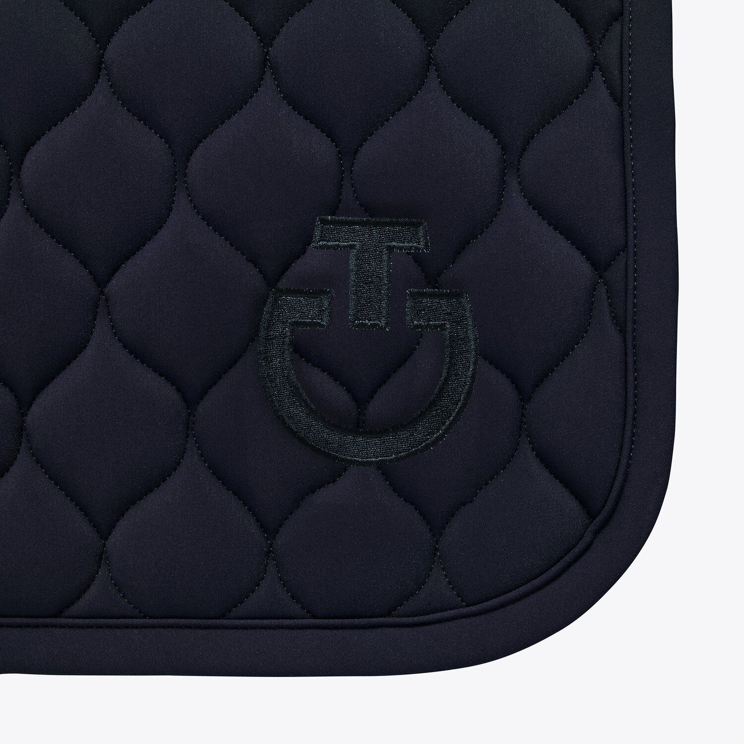 The Circular-quilted saddle pad from CT, made from breathable technical jersey. Available in Navy and finished with an embroidered black CT Logo and black edging.