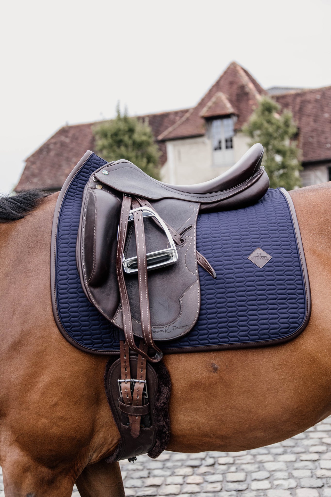This classy Kentucky dressage pad is designed with beautiful wave quilting and finished with a brown vegan leather trim and logo.