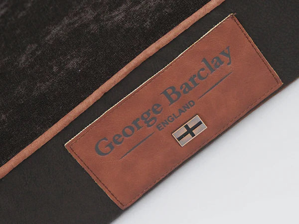 The George Barclay Monxton, sofa bed, has been produced using the finest quality upholstery fabric. A soft woven fabric covers the centre pillow and inner sidewalls, this is paired with contrasting faux leather exterior. The bed is finished with faux suede piping, with an embossed faux leather centre patch, which includes an English flag emblem to complete the beds signature styling.