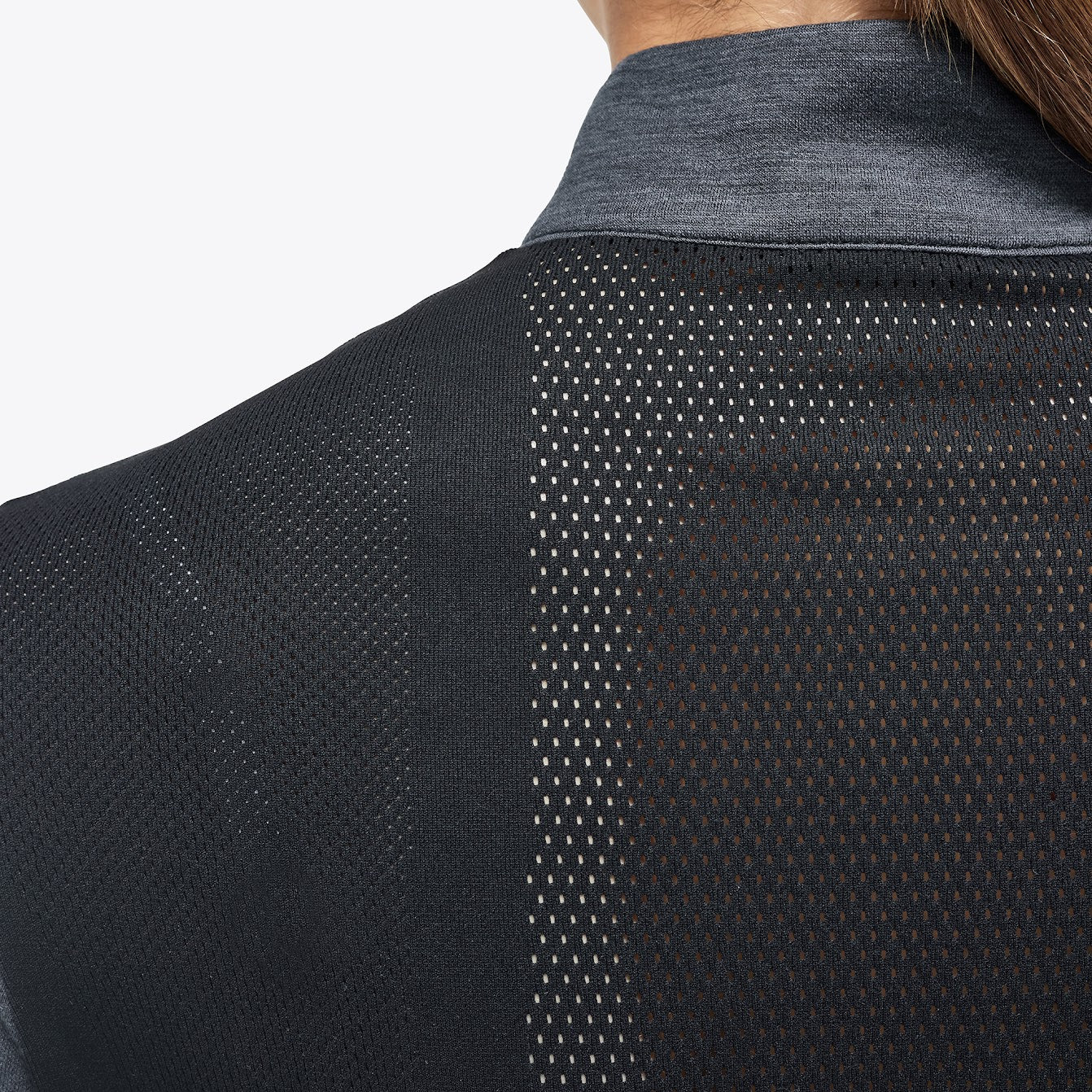The Cavalleria Toscana Grey and black Revolution Premier Tech Wool training top. The slimming silhouette is feminine yet sporty. Black fine tech knit back gives maximum freedom of movement. This CT training top is perfect for the shows, training or on the yard.