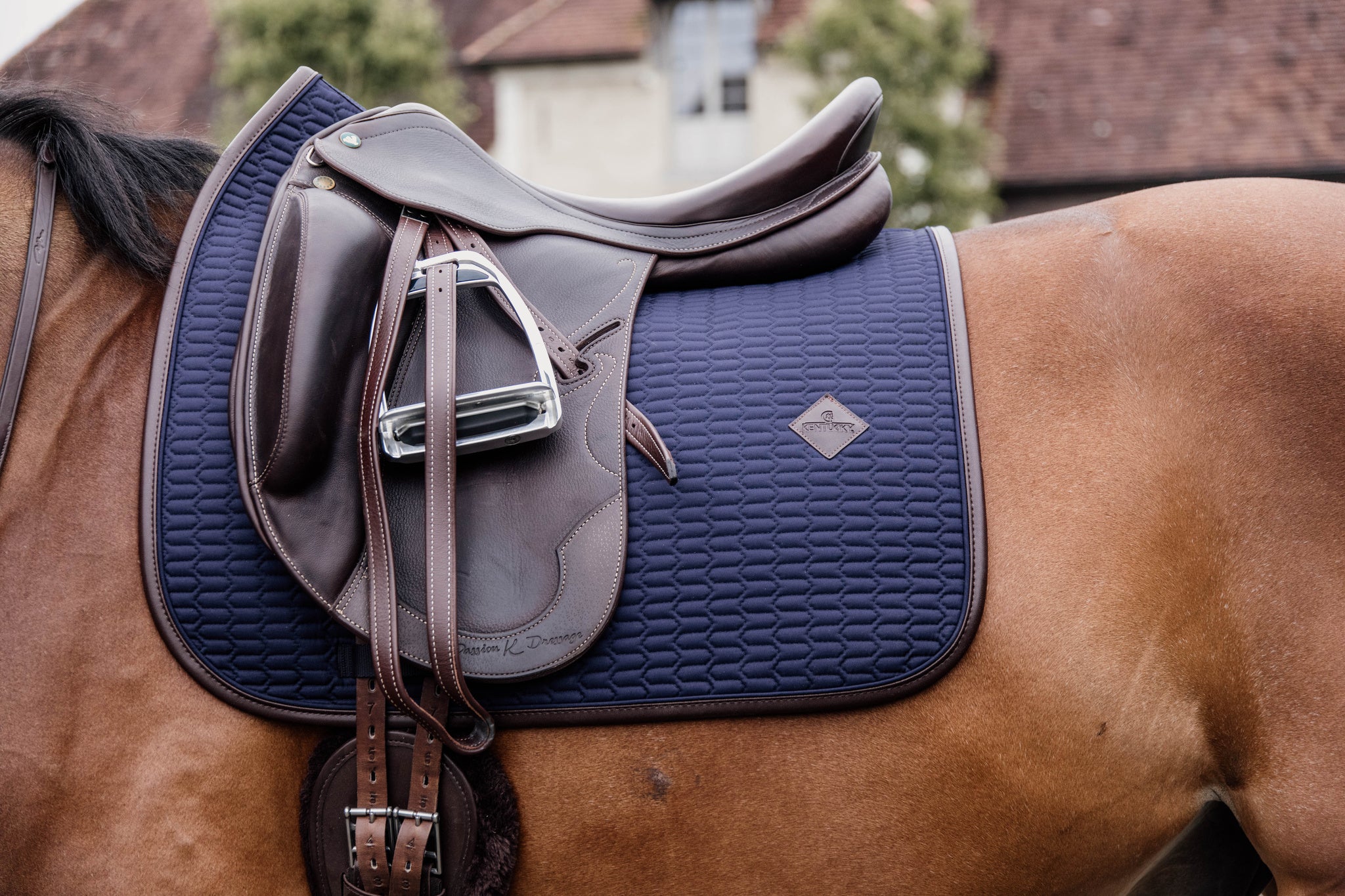 This classy Kentucky dressage pad is designed with beautiful wave quilting and finished with a brown vegan leather trim and logo.