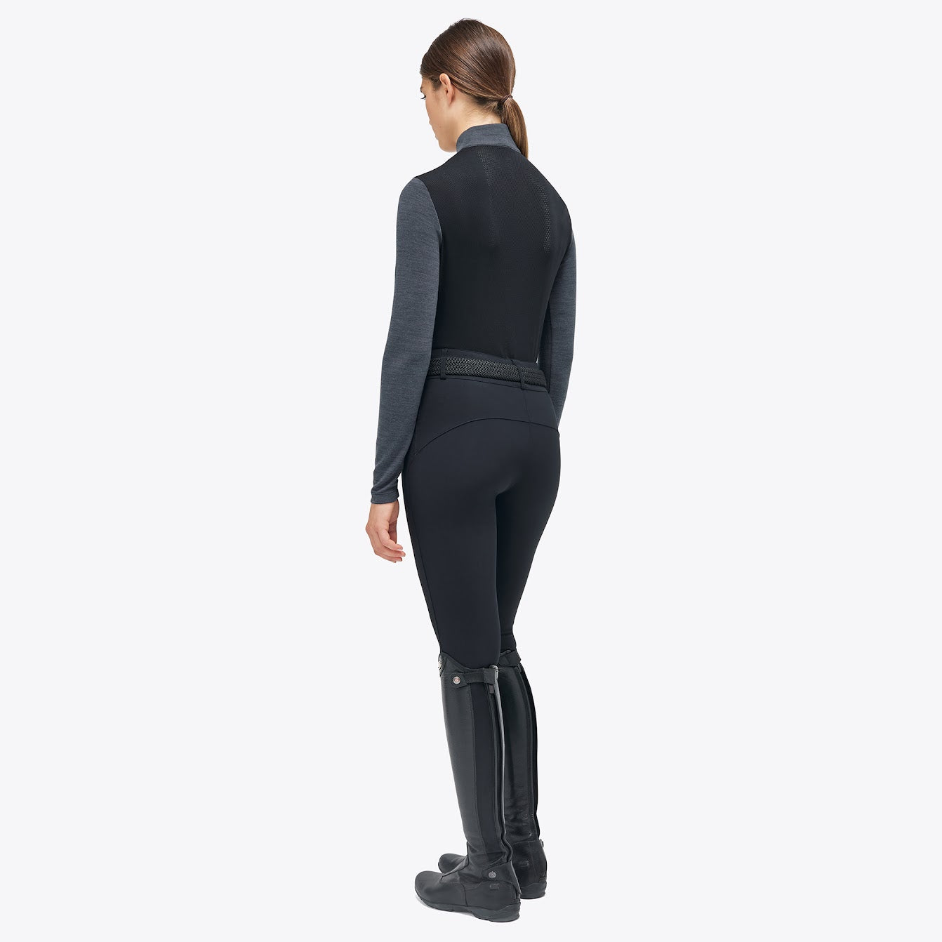The Cavalleria Toscana Grey and black Revolution Premier Tech Wool training top. The slimming silhouette is feminine yet sporty. Black fine tech knit back gives maximum freedom of movement. This CT training top is perfect for the shows, training or on the yard.