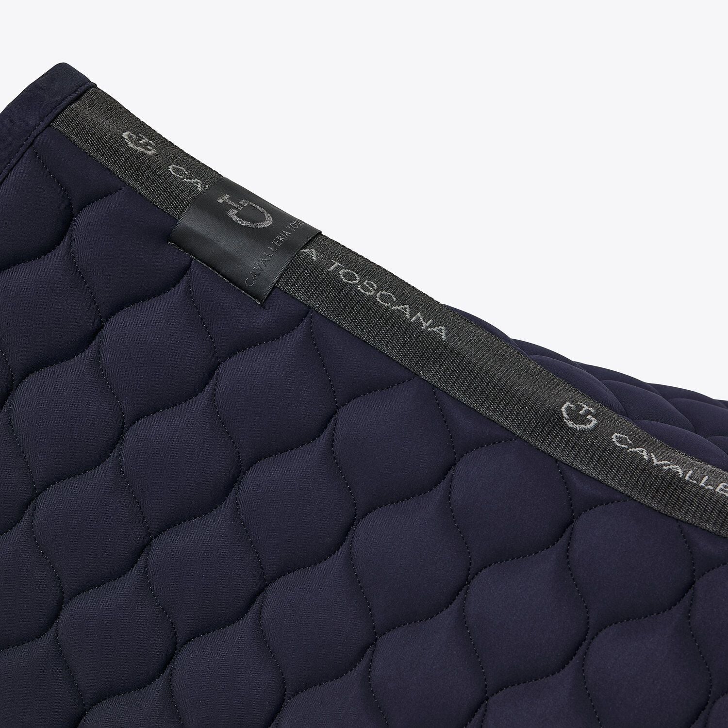 The Circular-quilted saddle pad from CT, made from breathable technical jersey. Available in Navy and finished with an embroidered black CT Logo and black edging.