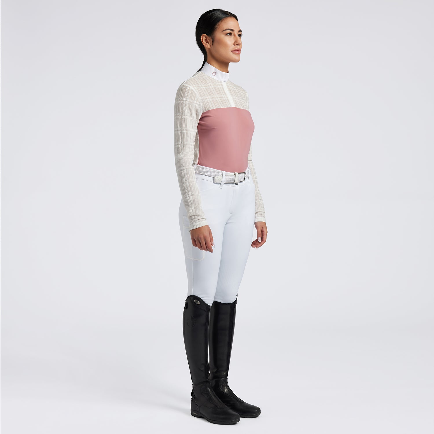 Showcase the Cavalleria Toscana Sheer Jacquard Jersey Zip Competition Shirt with images that emphasize its lightweight and breathable fabric. Highlight the sheer jacquard jersey material, zip closure, and tailored fit through a mix of close-up shots and action shots in an equestrian setting. Focus on the shirt&