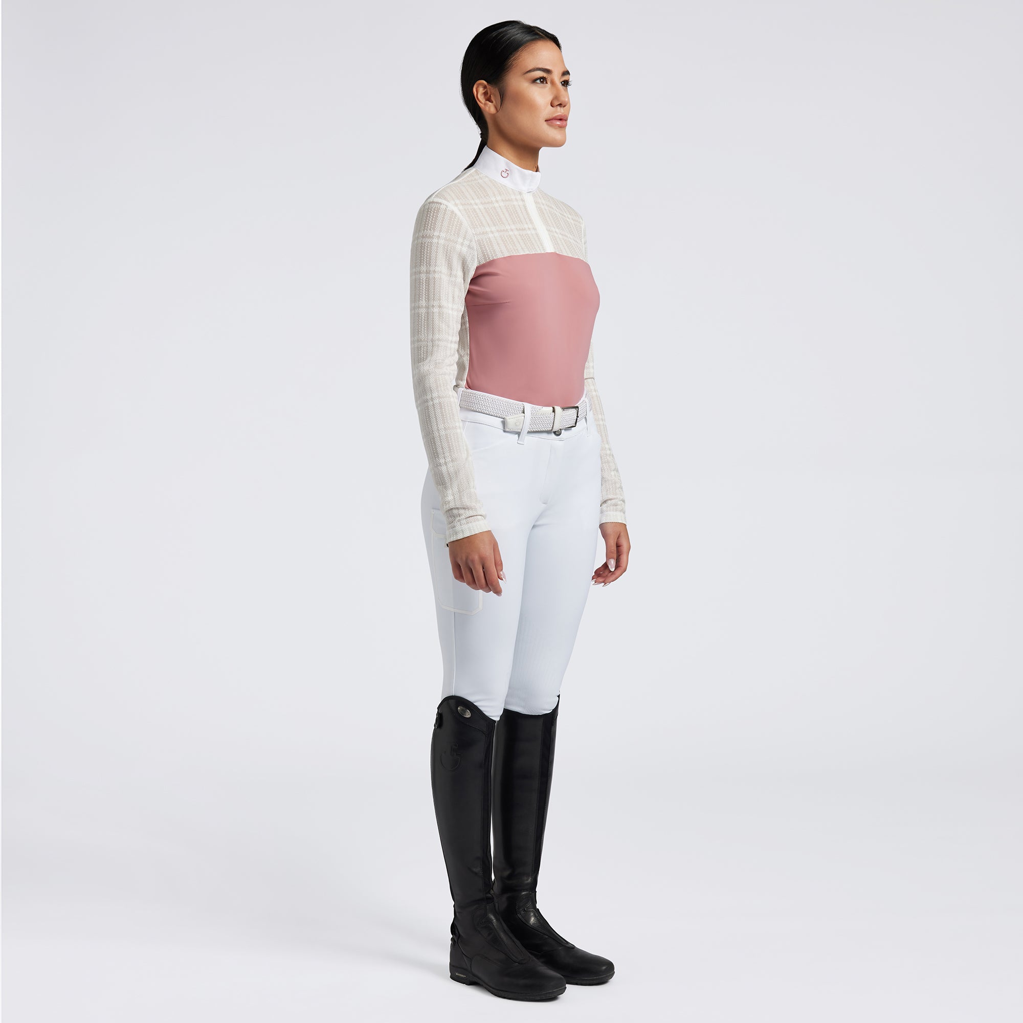Showcase the Cavalleria Toscana Sheer Jacquard Jersey Zip Competition Shirt with images that emphasize its lightweight and breathable fabric. Highlight the sheer jacquard jersey material, zip closure, and tailored fit through a mix of close-up shots and action shots in an equestrian setting. Focus on the shirt&