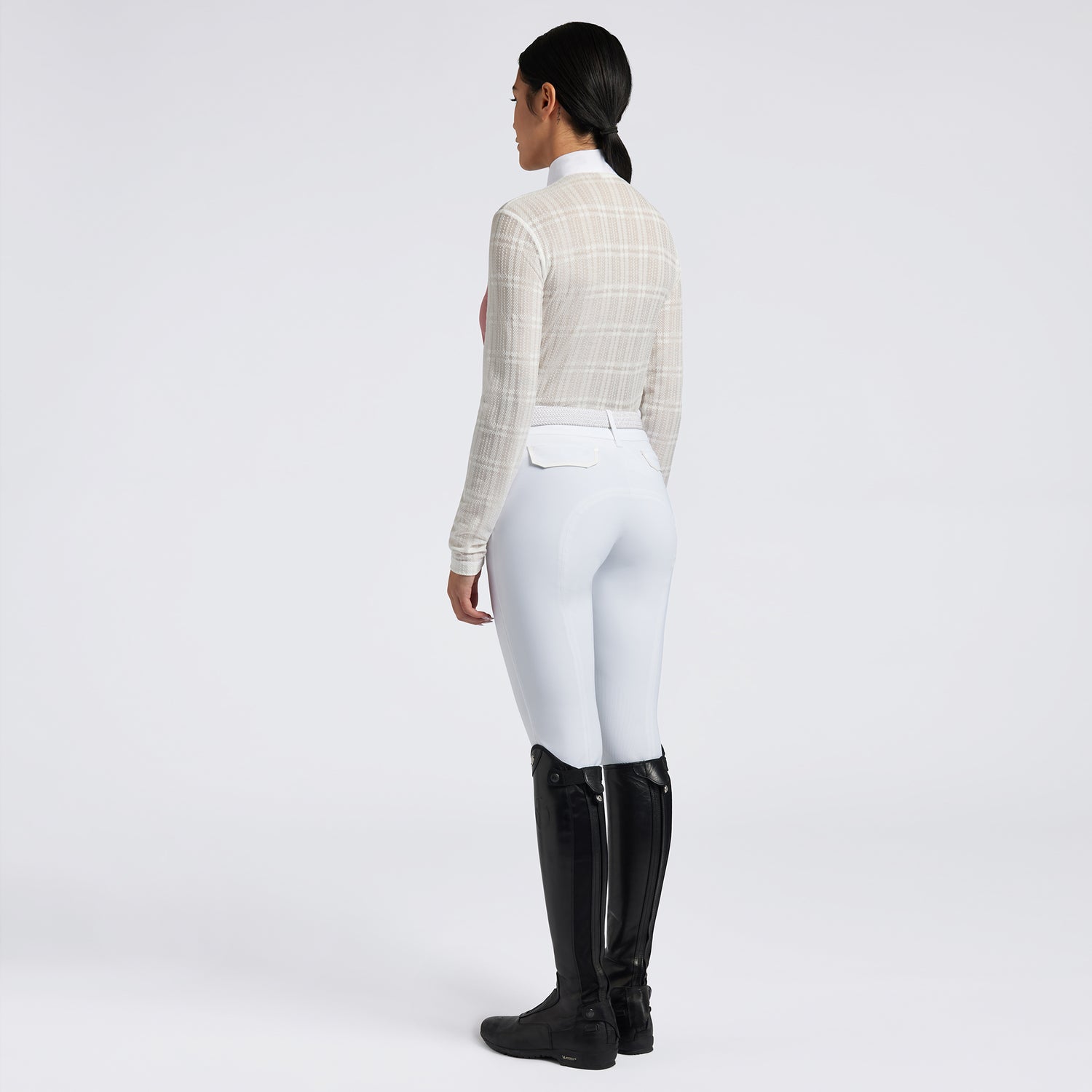 Showcase the Cavalleria Toscana Sheer Jacquard Jersey Zip Competition Shirt with images that emphasize its lightweight and breathable fabric. Highlight the sheer jacquard jersey material, zip closure, and tailored fit through a mix of close-up shots and action shots in an equestrian setting. Focus on the shirt&