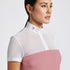 Highlight the Cavalleria Toscana Short Sleeve Perforated Jacquard Zip Competition Shirt through a variety of images that showcase its breathable fabric and sleek design. Include close-up shots of the perforated jacquard material and the zip closure, as well as action shots that demonstrate the shirt’s performance in an equestrian setting. Focus on the short sleeve design and the tailored fit, emphasizing both style and functionality.