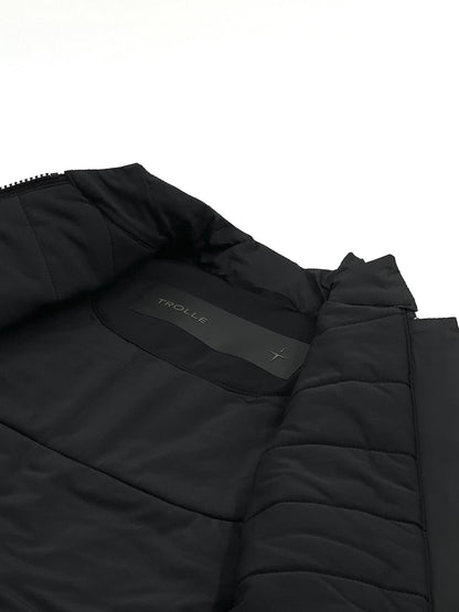 Close-up of a black quilted jacket with a brand logo on a white background