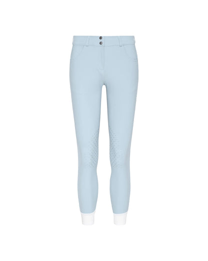 Light blue riding breeches with textured grip panels on the thighs and white cuffs, shown against a plain white background.
