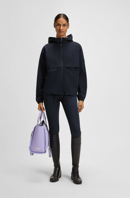 Person wearing a black outfit holding a purple bag on a white background