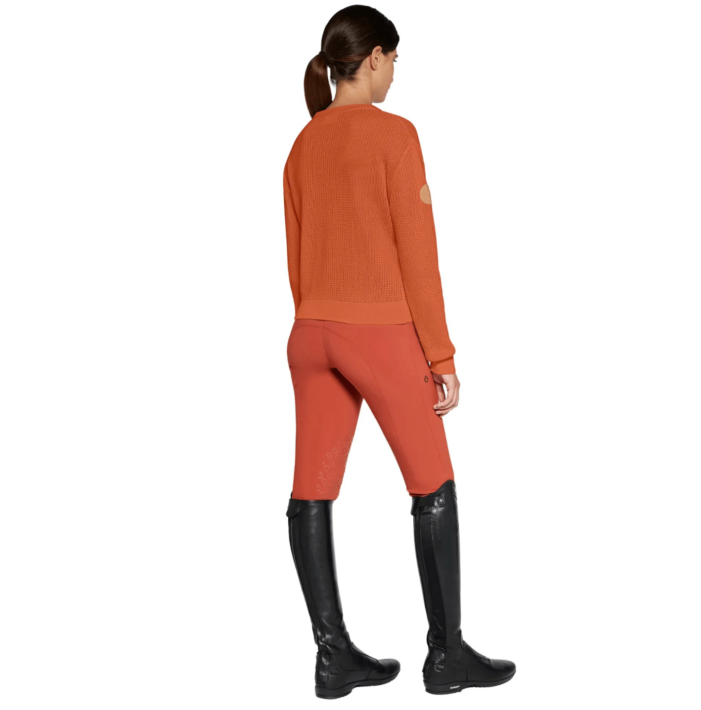 Equestrian rider wearing Cavalleria Toscana Cotton Knit Crew Neck Sweater in striking orange, showcasing timeless style