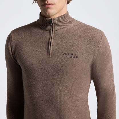 A man wearing a brown ribbed knit quarter-zip sweater with &
