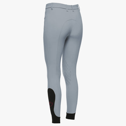 Winward blue equestrian riding breeches shown from the back, featuring black knee patches and black ankle cuffs, on a light gray background