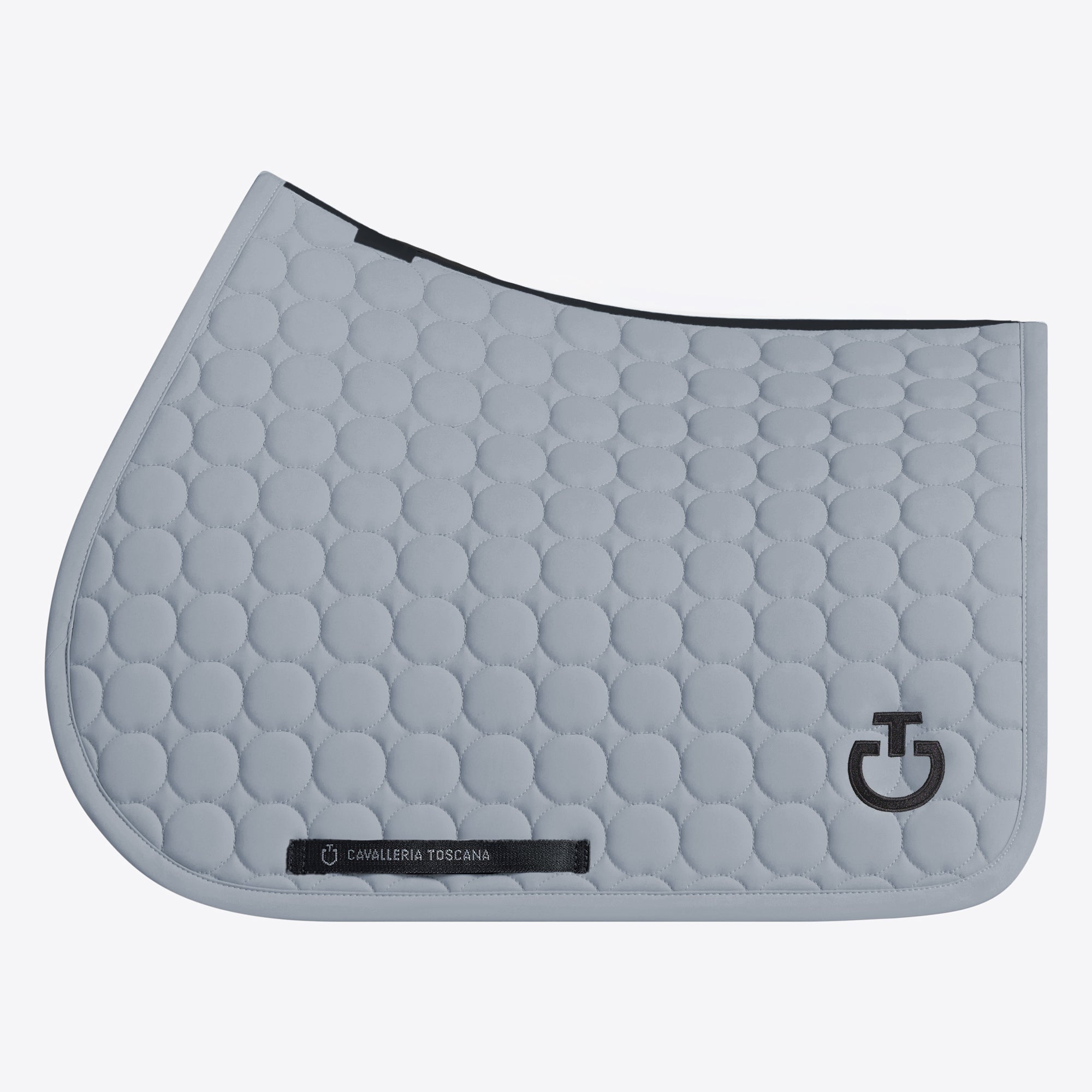 A light gray quilted horse saddle pad with a circular bubble pattern, featuring a black logo on the lower right and a black brand label near the bottom left, set against a plain light gray background.