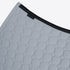 Close-up of a light gray quilted mattress topper with a circular stitched pattern and a black elastic band featuring the brand name &