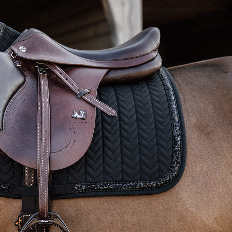Let your horse shimmer with the Kentucky dressage Glitter and Stone Pad. The pad is of the usually high quality you know from Kentucky with excellent cushioning between the horse’s back and the saddle and therefore protecting the horse against friction.    matching fly vale available in standard and soundless options.   Machine washable at 30’c in a wash bag. 