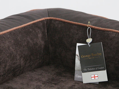 The George Barclay Monxton, sofa bed, has been produced using the finest quality upholstery fabric. A soft woven fabric covers the centre pillow and inner sidewalls, this is paired with contrasting faux leather exterior. The bed is finished with faux suede piping, with an embossed faux leather centre patch, which includes an English flag emblem to complete the beds signature styling.