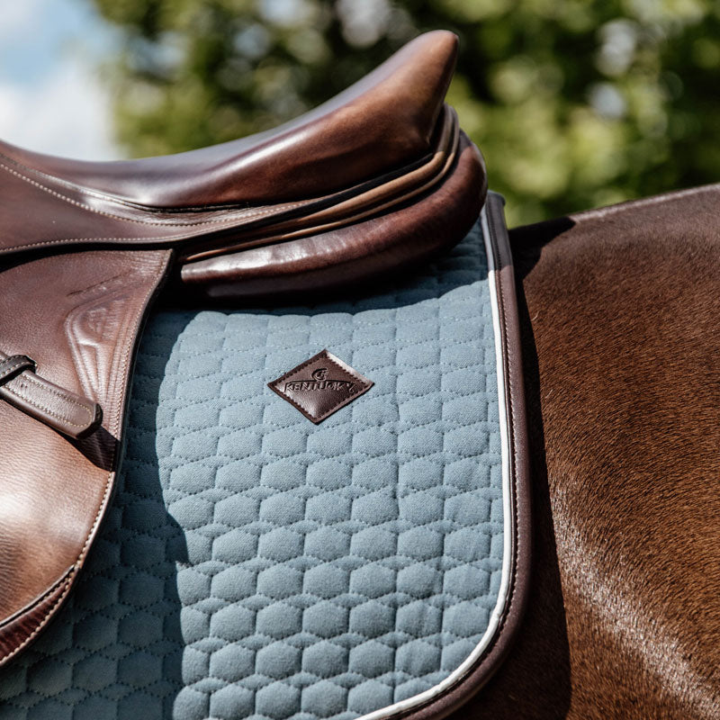 This classy Kentucky dressage pad is designed with beautiful quilting and finished with a brown vegan leather trim and logo. 