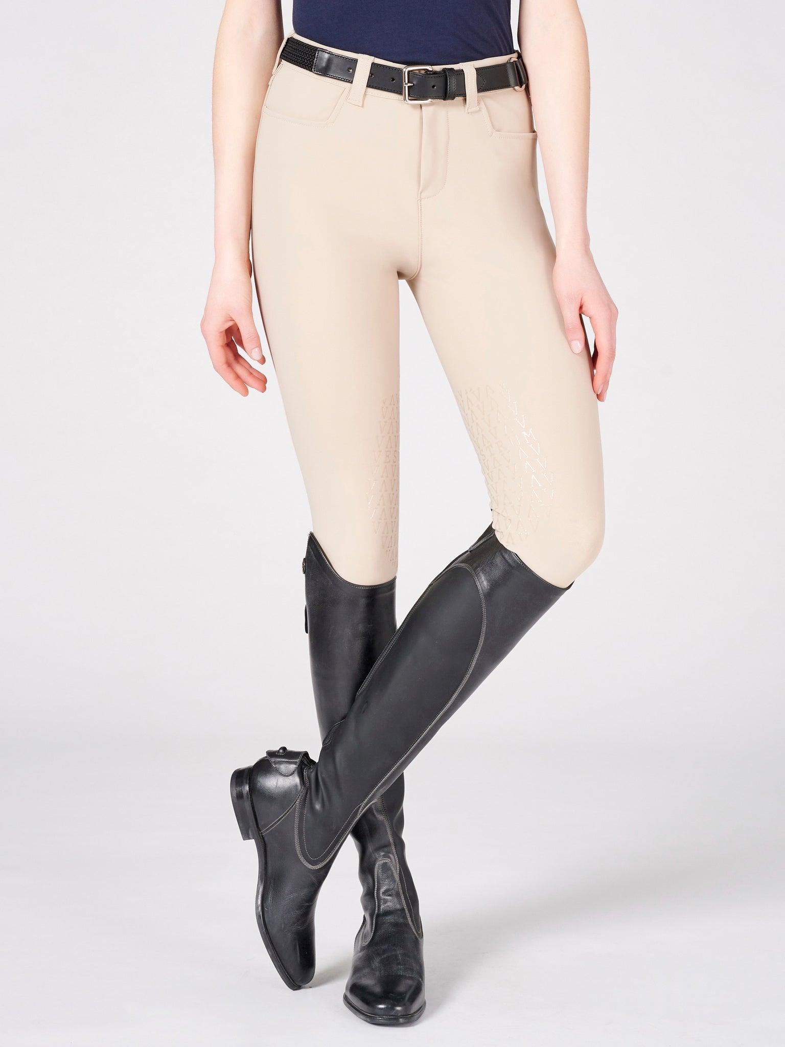 The beige Vestrum Syracuse Sage V Grip Breeches are a timeless and indestructible basic they constantly improve. The bi stretch technical fabric give maximum movement and comfort for the rider. These Vestrum breeches are extremely comfortable and have a flattering fit. These mid wait breeches have two front pockets, no back pockets and a knee grip. The breeches are beige with a dark tan  iconic Vestrum logo. 