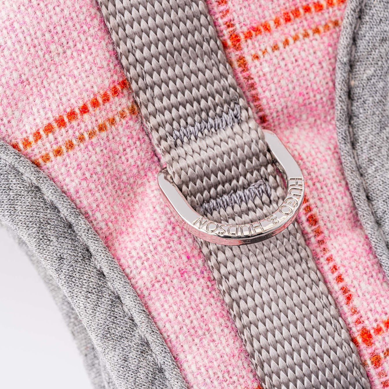Hugo and Hudson Pink Tweed Harness   The pink dog harnesses are designed to help prevent your dog from pulling, whilst reducing pressure on their neck. The harness is designed so your dog will look and feel great, with four different sizes, that are adjustable , are available to get the perfect fit.  Complete the pink checked set with the lead, collar and checked herringbone tweed jacket.