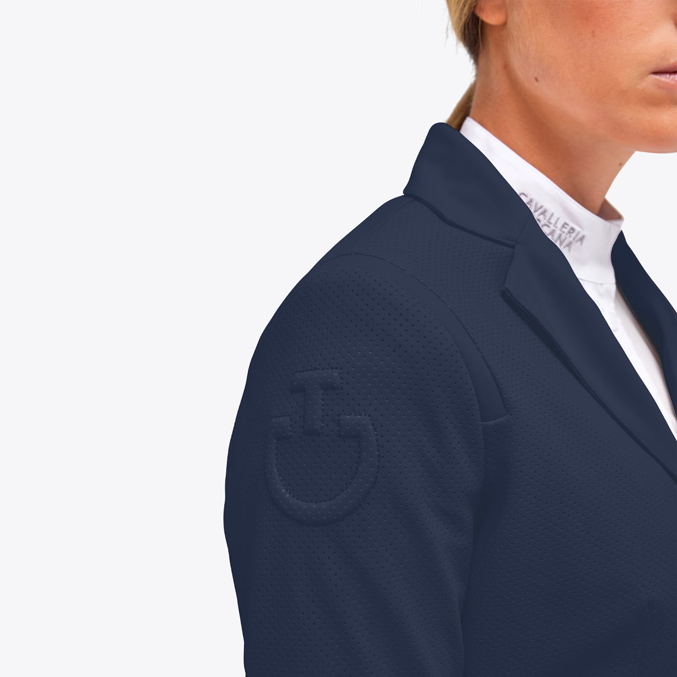 The Cavalleria Toscana All Over Perforated Show Jacket in blue. The perforation offers breathability and maximum movement when performing. Detailing over the shoulders gives a slimming effect with the CT logo on the sleeve. 