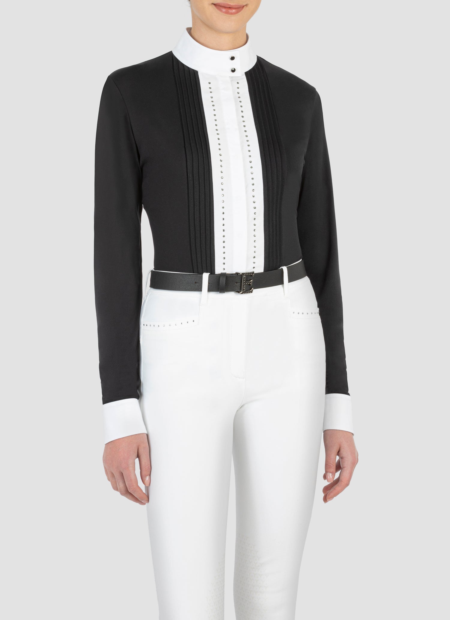 Equiline’s long sleeve show shirt has a twin line of diamanté’s running either side of the button placket gives a stunning look. Jersey fabric with woven placket and cuffs.  Available in black and white and all white. 
